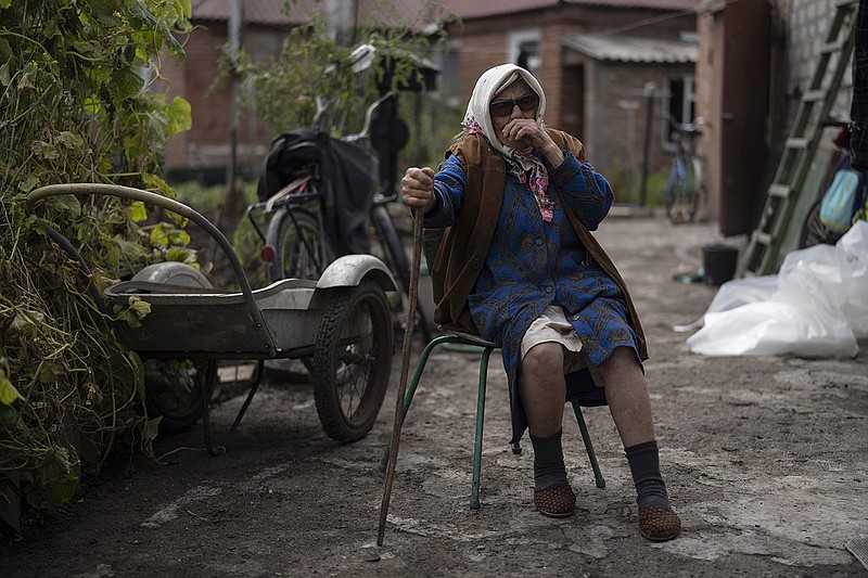 Mariia Ruban, 92, sits on a chair as she talks about the moments of the explosion next to her house that damaged its roof and windows after a Russian attack in Sloviansk, Ukraine, Tuesday, Sept. 6, 2022. Ruban says she was pushed off her bed by the force of the blast and lost her conscious. "There was nobody around, nobody could help me", she completes. (AP Photo/Leo Correa)