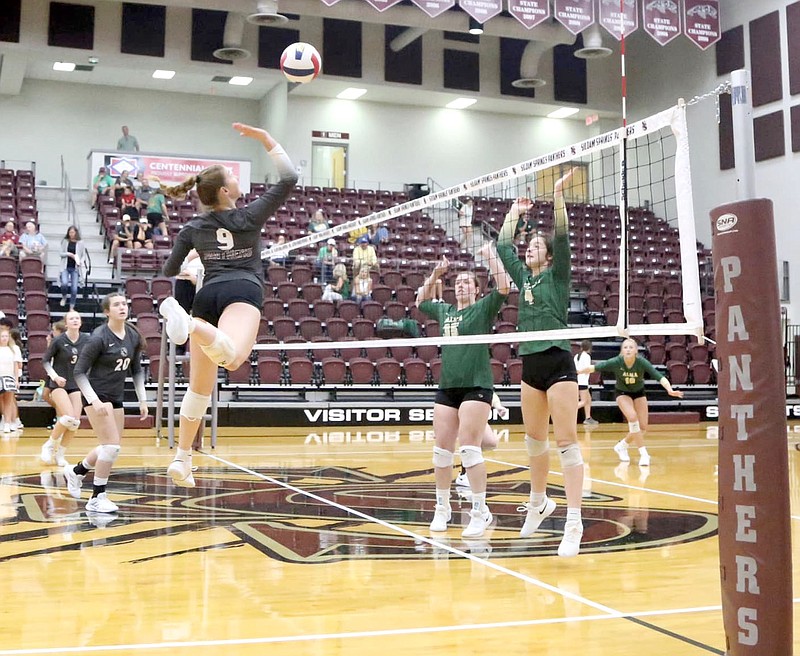 Mark Ross/Special to The Herald-Leader
Siloam Springs senior Faith Ellis (left) goes high into the air against Alma blockers Sam Crook and Jenna Williams during a 5A-West Conference volleyball match on Thursday, Sept. 8. Alma defeated Siloam Springs 3-1.