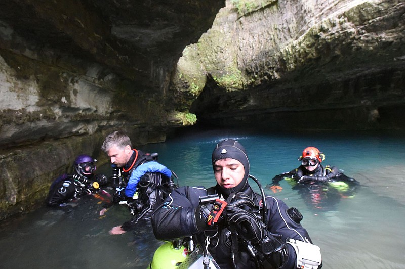 Divers, including marine biologist Fernando Calderon (center) of Galveston, Texas, get ready on Aug. 20 2022 to dive deep into Roaring River Spring. A team from KISS Rebreathers, based in Fort Smith, has three more exploration dives scheduled this year.