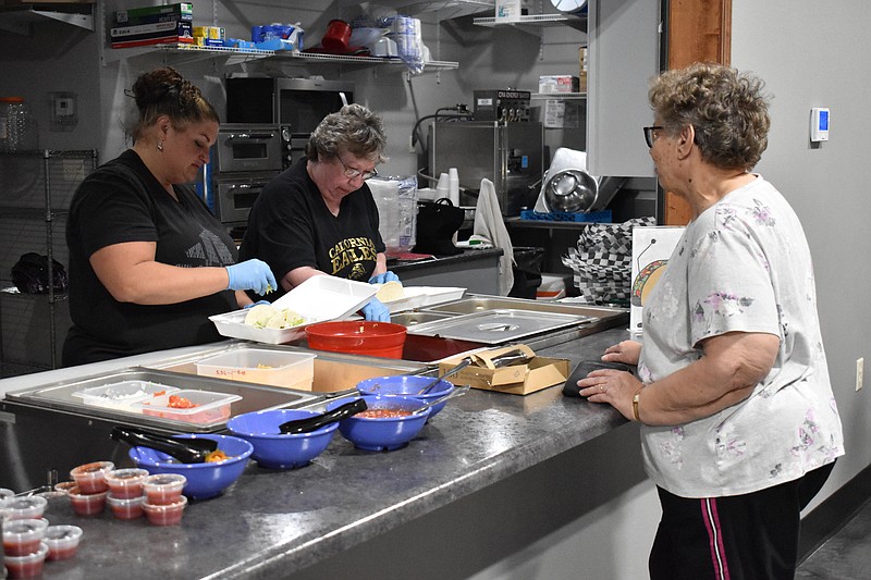 Democrat photo/Garrett Fuller — Linda Bestgen, right, watches as Tina Wilde, left, and Barb Cornine make tacos for her order Wednesday (Sept. 7, 2022,) during the California Fraternal Order of Eagles scholarship taco dinner at the Eagles club.