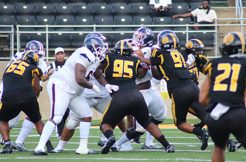 UAPB defensive linemen Kenny Clark (95) and Anas Luqman (91) pressure Lane quarterback Michael Huntley (12) in the first half of their Sept. 3 game at Simmons Bank Field at Golden Lion Stadium. (Special to The Commercial/Jamie Hooks)