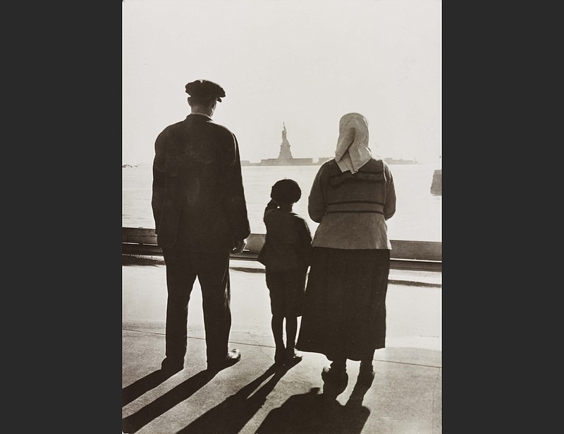 An immigrant family looks at the Statue of Liberty from Ellis Island, N.Y., circa 1930. (Courtesy of Library of Congress)