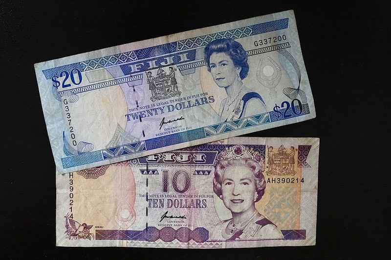 Fiji $10 and $20 bills bills are pictured in Sydney, Saturday, Sept. 10, 2022. As the United Kingdom's reigning monarch, Queen Elizabeth II was depicted on British bank notes and coins for decades. It's less well known that her portrait was featured on currencies in dozens of other places around the world, in a reminder of the British empire's colonial reach. (AP Photo/Mark Baker)