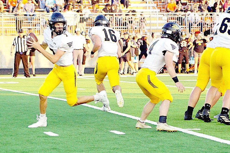 RANDY MOLL  EAGLE-OBSERVER/Prairie Grove senior quarterback Camden Patterson drops back to pass with one back, Ethan Miller, going into a pattern and another, fullback Coner Whetsell, staying in to block.