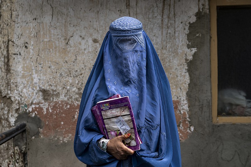 Arefeh, 40 years old, leaves an underground school, in Kabul, Afghanistan, Saturday, July 30, 2022. Taliban authorities Saturday, Sept. 10, 2022, shut down girls schools above the sixth grade in eastern Afghanistan's Paktia province that had been briefly opened after a recommendation by tribal elders and school principals, according to witnesses and social media posts. (AP Photo/Ebrahim Noroozi)