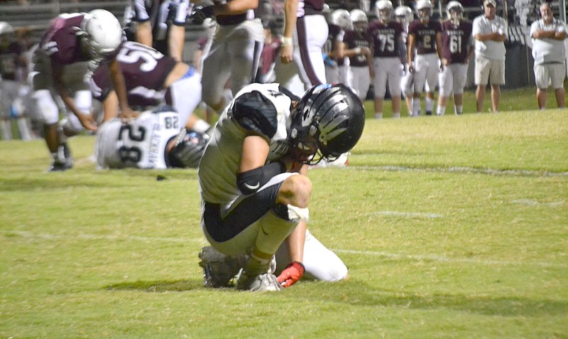 TIMES photographs by Annette Beard
In the waning minutes of the game, senior Evan Anderson, No. 4, dropped to one knee in pain after being injured in the previous play. Anderson was escorted off the field by trainer Hunter Wright. For more photographs, go to the PRT gallery at https://tnebc.nwaonline.com/photos/.