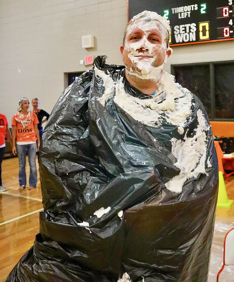 Submitted Photo
Gravette Middle School principal Taos Jones still has a smile on his face, even after receiving a few pies in the face during the school's ACT Aspire test scores celebration Thursday, Sept. 8. Jones told the GMS students he would agree to the stunt if their scores ranked in the top 10% regionally. When they exceeded that ranking he was happy enough to provide a little entertainment at the school's celebration.