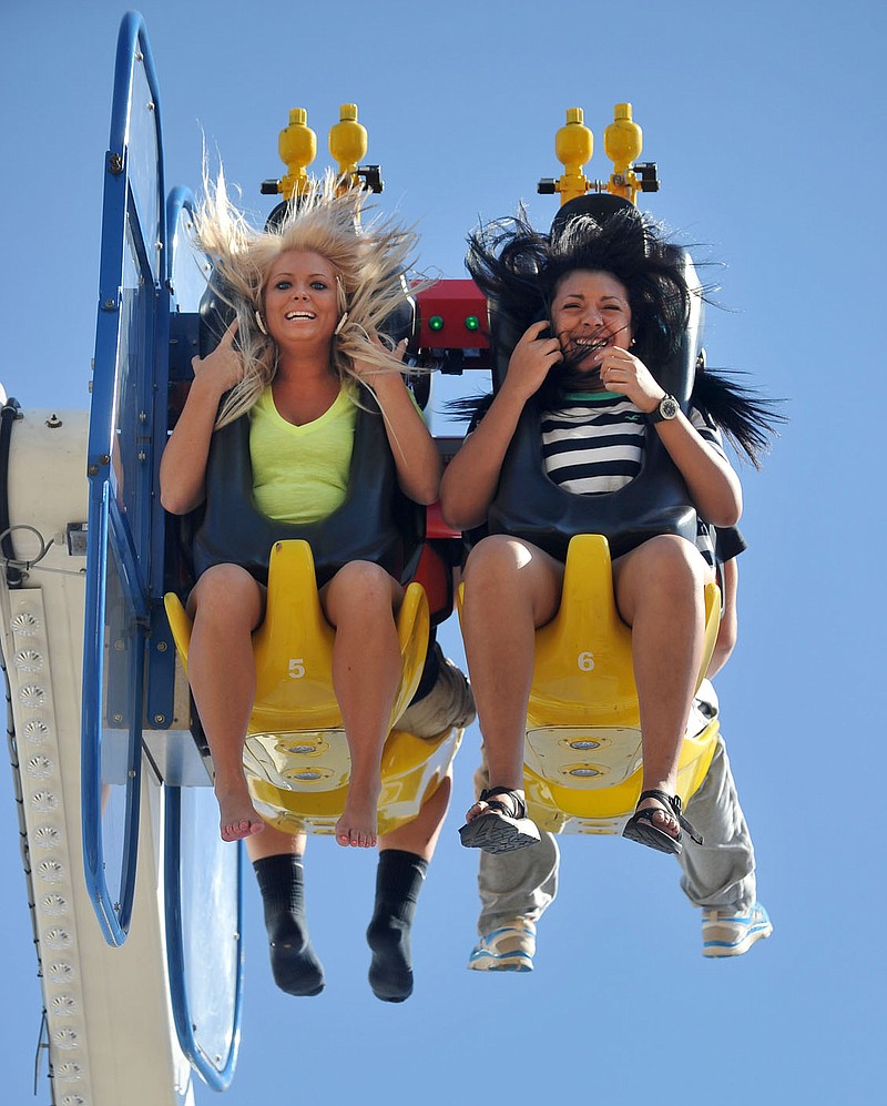 NWA Media/MICHAEL WOODS --09/25/2013--   Nikki Dye (left) and 17 and Tia Wade, age 18, both from Poteau, Oklahoma spin around on the Speed ride Wednesday afternoon at the Arkansas Oklahoma State Fair at Kay Rodgers Park in Fort Smith.  The fair runs through Saturday September 28th and has a variety of events throughout the day including a 7:30 bull riding event Thursday evening, an 8:00 pm by Sevendust Friday evening, and a Saturday evening Demolition Derby and antique Tractor pull to end the event Saturday evening.