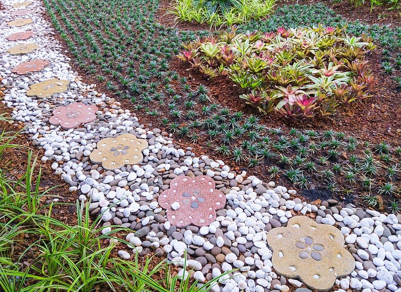 A sweet path of flower shaped concrete stones brings movement to this space. (istockphoto.com/trainman111)