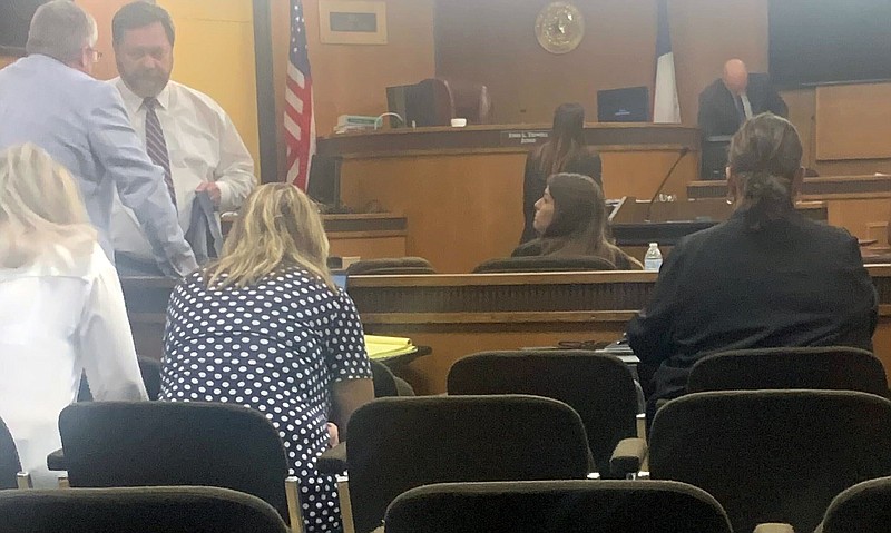 Taylor Parker, center, listens to her attorney Jeff Harrelson, third from left, during a break in her capital murder trial Tuesday, Sept. 13, 2022, at the Bowie County Courthouse in New Boston, Texas. Parker is charged with capital murder and could face the death penalty in the Oct. 9, 2020, killing of expectant mother Reagan Simmons Hancock of New Boston and the taking of her unborn child, who also died. Parker has pleaded not guilty. (Staff photo by Lori Dunn)
