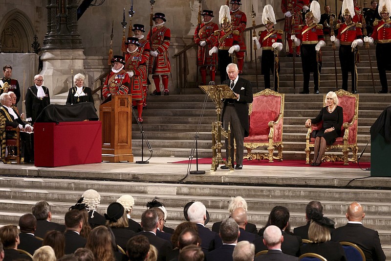 Britain's King Charles III stands as he addresses members of parliament at Westminster Hall, where both Houses of Parliament are meeting to express their condolences following the death of Queen Elizabeth II, at Westminster Hall, in London, Monday, Sept. 12, 2022. Queen Elizabeth II, Britain's longest-reigning monarch, died Thursday after 70 years on the throne. (Henry Nicholls/Pool Photo via AP)