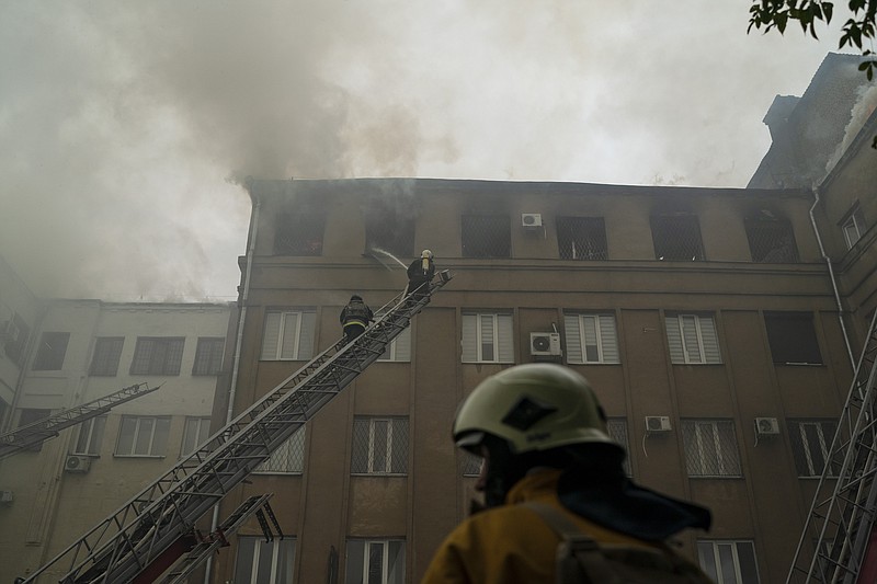 Firefighters work to extinguish a fire after a Russian attack that damaged a police building in Kharkiv, Ukraine, Monday, Sept. 12, 2022. (AP Photo/Leo Correa)