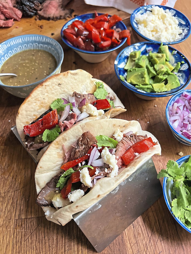 Served with all the traditional toppings these grilled steak tacos get an extra boost of flavor from a spicy chili-lime marinade. (Gretchen McKay/Pittsburgh Post-Gazette/TNS)