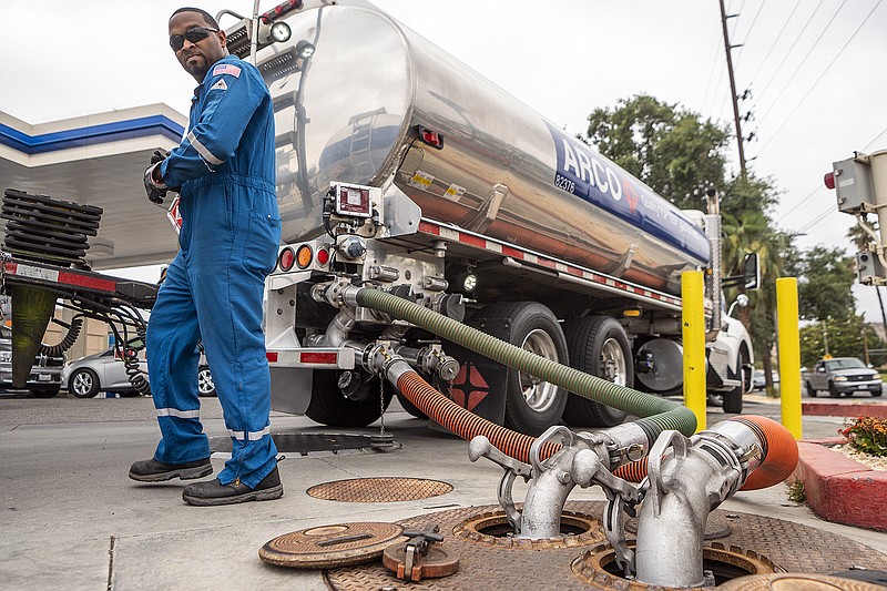 A driver delivers 8,500 gallons of gasoline at an ARCO gas station in Riverside, California, Saturday, May 28, 2022. (AP Photo/Damian Dovarganes, File)