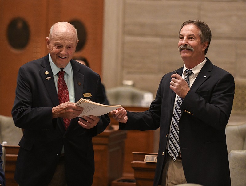 Julie Smith/News Tribune photo: 
Sen. Mike Moon, R-Springfield, right, hands doorkeeper Gil Schellman copies of proposed bills while addressing the Missouri Senate Chamber Wednesday, Sept. 14, 2022, during special session.