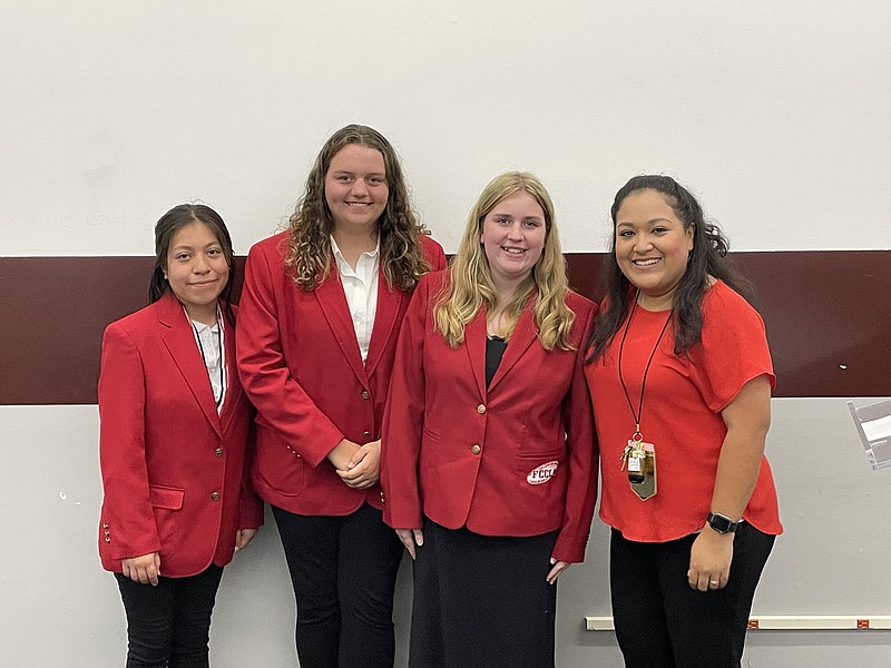 Siloam Springs High School Family, Career and Community Leaders of America members Yareli Cecilio, Reese Sutulovich and Addison Kiefer are joined by advisor Jenny Marroquin on Sept. 8 during the School Board meeting.

(NWA Democrat-Gazette/Spencer Bailey)