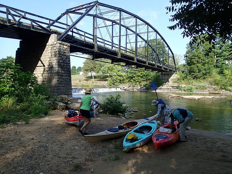 Paddlers get boats ready for a trip along the War Eagle River and into the headwaters of Beaver Lake. 
(NWA Democrat-Gazette/Flip Putthoff)