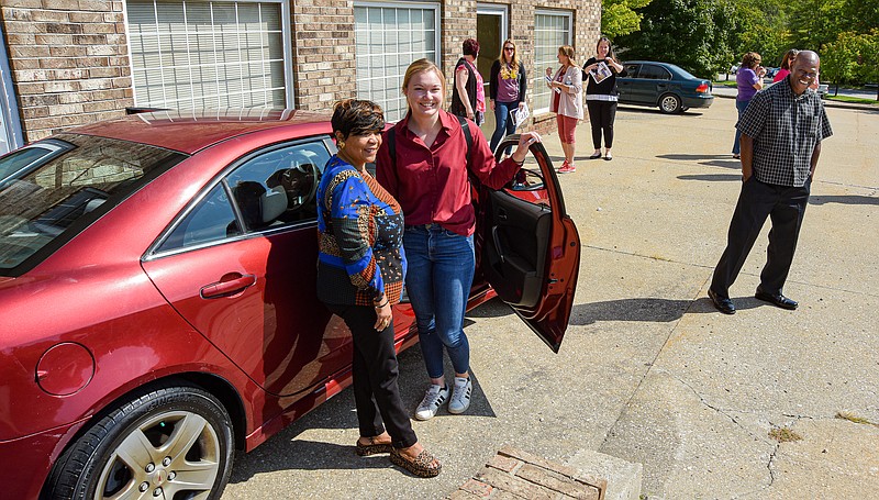 Julie Smith/News Tribune
Anthony Conway, at right, stands with a huge smile on his face as he proudly watches Gwendolyn Jennings, left, and Paige Rackers pose near the car Conway delivered to them. Jennings and Rackers are with Rape and Abuse Crisis Service and have a client who will be the recipient. Conway is with Cars 4 Columbia and Caring Cars and found the vehicle to fill this need.