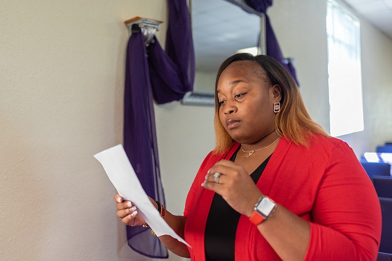 Lady Kyra Hatton reads through information for "Broken But Im On My Way," a women's ministry conference planned for Saturday, Oct. 1, 2022, at New Birth Spirit Filled Ministries in Texarkana, Arkansas. (Staff photo by Erin DeBlanc)