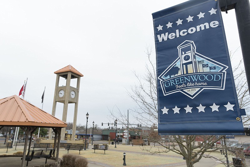 A welcome sign displays on March 11 in front of the clock tower at Greenwood Town Square in Greenwood.  
(NWA Democrat-Gazette/Hank Layton)