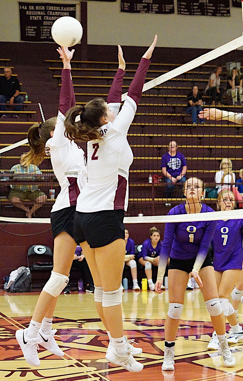 Westside Eagle Observer/RANDY MOLL
Gentry juniors Kelsi Amos and Reese Hester attempt to block an Ozark kill attempt during play between the two teams on Thursday at Gentry High School.