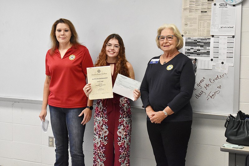 Paula Harmon, left, and Dorothy Goodin, right, present Emily Jurgle with a check and certificate Thursday (Sept. 15, 2022,) during class at Russellville High School for winning the American Legion Auxiliary's Americanism essay contest at the state level. Jurgle's teacher, Denise Crider, inspired her to write the essay responding to a prompt asking how we can better support veterans' caretakers and families. (California Democrat photo/Garrett Fuller)