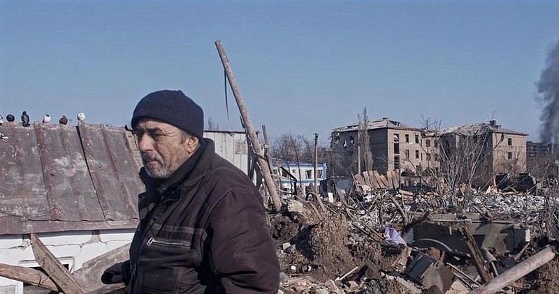 In this image from "Mariupolis 2," provided by the Hot Springs Documentary Film Festival, a man walks past some of the destroyed buildings in Mariupolis. The film is one of the selections for this year’s event. - Submitted photo