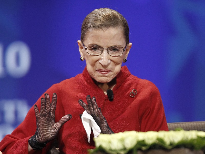 FILE - Supreme Court Associate Justice Bader Ginsburg is seen on stage at the Women's Conference Tuesday, Oct. 26, 2010, in Long Beach, Calif. A collection of nearly 100 items is being sold in an online auction that begins Wednesday, Sept. 7, 2022, and runs through Sept. 16, including a pair of black gloves owned by Ginsburg. It concludes just before the two-year anniversary of Ginsburg's death at 87. The proceeds will benefit SOS Children’s Villages, an organization that supports vulnerable children around the world. (AP Photo/Matt Sayles, File)