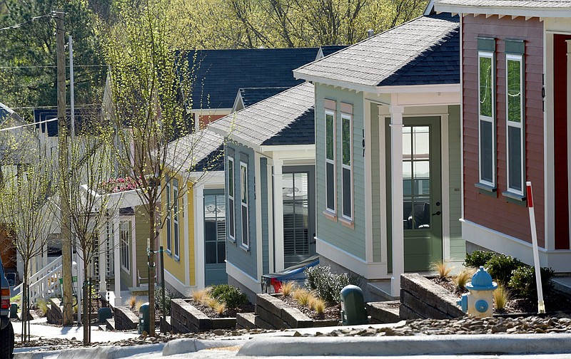 Houses on East Ninth Street near the intersection of South College Avenue are visible April 15, 2019, in Fayetteville. Planners say the row of new homes developed by Zara and Gina Niederman in the Walker Park neighborhood serve as an example of the kind of designs that could be included in a "pattern book" available to developers. (File photo/NWA Democrat-Gazette/David Gottschalk)