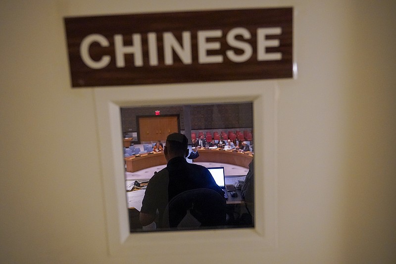 A Chinese translator works during a Security Council meeting at United Nations headquarters ahead of the General Assembly, Friday, Sept. 16, 2022. As world leaders gather in New York at the annual U.N. General Assembly, rising superpower China is also focusing on another United Nations body that is meeting across the Atlantic Ocean in Geneva.  (AP Photo/Mary Altaffer)