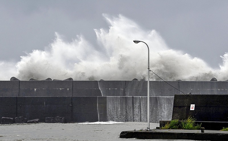 High waves hit the breakwater at a port in Aki, Kochi prefecture, southern Japan, Sunday, Sept. 18, 2022, as a powerful typhoon approaching southern Japan on Sunday lashed the region with strong winds and heavy rain.(Kyodo News via AP)
