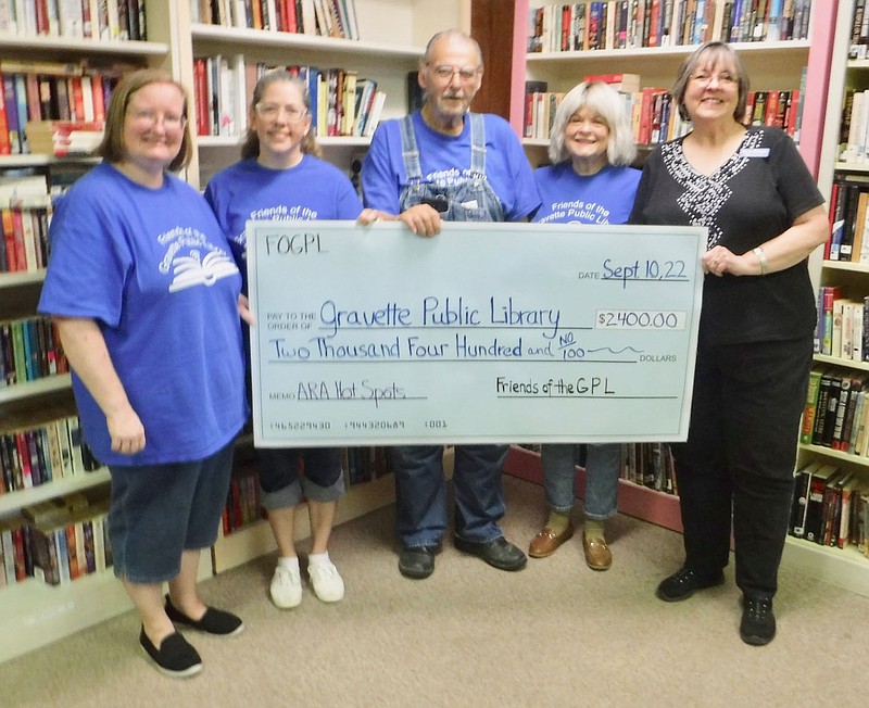 Friends of Gravette library accept donation, hold ribbon cutting