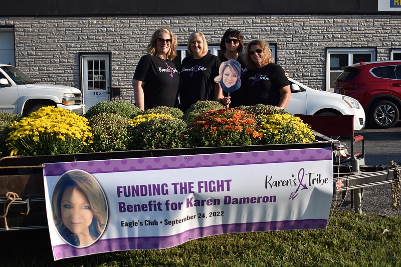 Democrat photo/Garrett Fuller — Karen's Tribe: Funding the Fight organizers, from left, Tracy Upschulte, Shelly Hampton, Karen Phillips and Tammy Bleich pose for a photo Saturday (Sept. 17, 2022,) during a mum sale outside Ace Realty in California. The four, along with Alicia Carpenter (not pictured), have been planning a benefit for Karen Dameron, a local resident who has been preparing for a stem cell transplant after being diagnosed again with Hodgkin's lymphoma, a form of cancer that affects the immune system. The benefit, consisting of a pork steak dinner, live and silent auctions, raffle, and live entertainment, will begin at 4 p.m. Saturday (Sept. 24, 2022,) at the California Fraternal Order of Eagles building. The silent auction will start at 1 p.m. Saturday.