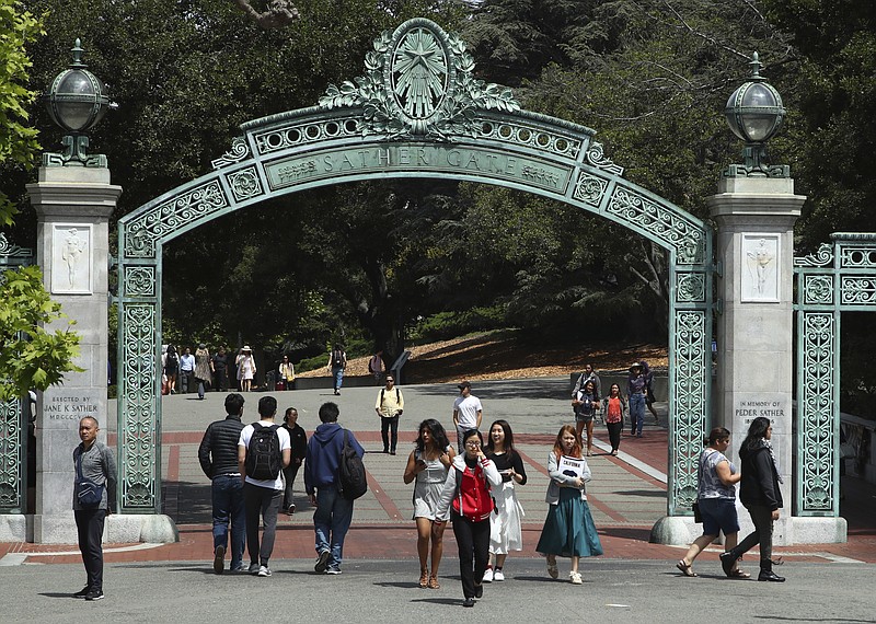 Students walk past Sather Gate at the University of California at Berkeley on May 10, 2018, in Berkeley, Calif. President Joe Biden's student loan forgiveness plan, announced in August 2022, could lift crushing debt burdens from millions of borrowers. However, the tax man may demand a cut of the relief in some states, as some states tax forgiven debt as income. (AP Photo/Ben Margot, File)