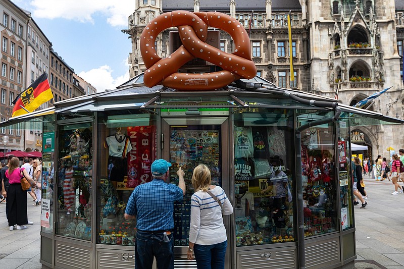 Customers look at Germany- and Munich-themed stickers, badges and other mementos at a souvenir kiosk in Munich. MUST CREDIT: Bloomberg photo by Krisztian Bocsi.