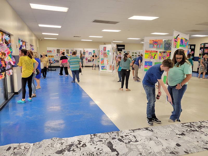 Visitors and students observe artwork at the Redwater ISD Art Show. (Submitted photo)