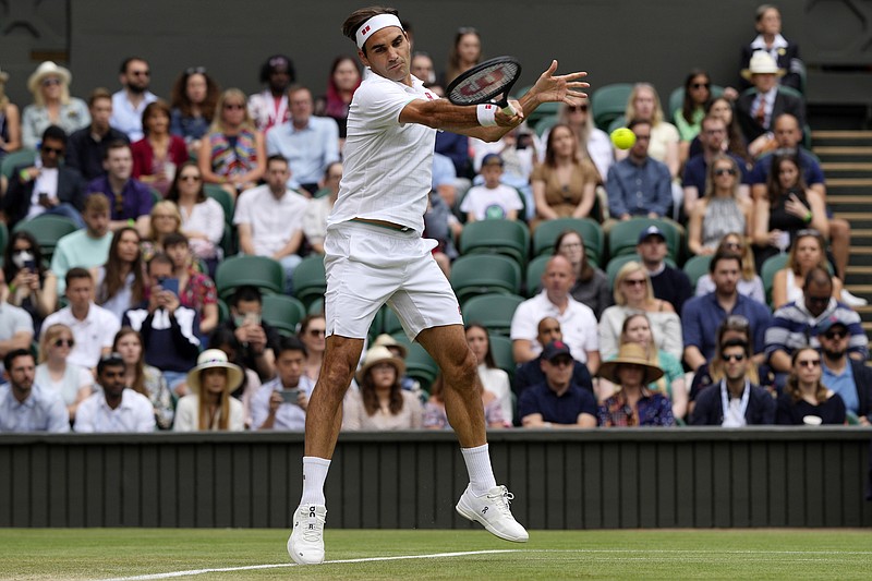 FILE - Switzerland's Roger Federer plays a return to Britain's Cameron Norrie during the men's singles third round match on day six of the Wimbledon Tennis Championships in London, Saturday July 3, 2021. Federer announced Thursday, Sept.15, 2022 he is retiring from tennis. (AP Photo/Alastair Grant)
