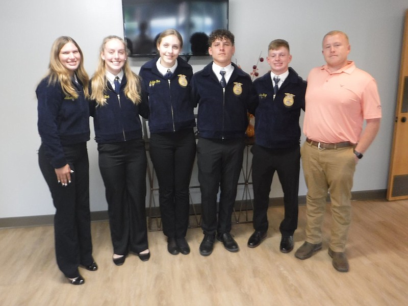 Westside Eagle Observer/SUSAN HOLLAND Members of the Gravette Future Farmers of America chapter and their sponsor, agriculture teacher Justin Malott (right), pose for the camera after making a presentation at the Sept. 19 meeting of the Gravette School Board. Board members approved the students’ request to attend the national FFA convention in Louisville, Ky. Pictured are Autumn Fisher, Kassi Bird, Ashlyn Fox, Clayton Nall, Jake Mayor and Malott.