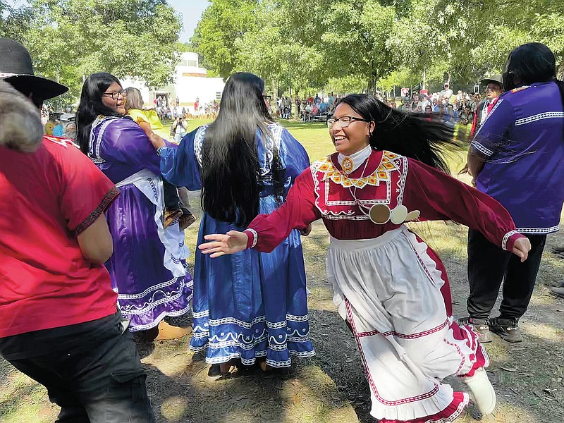 Isley Phillips, 18, chases her brother Noah, 19, and his raccoon-tail hat on Saturday as part of their traditional Raccoon Dance in Macon, Ga. The teenagers are members of the Mississippi Band of Choctaw Indians and performed at the 30th annual Ocmulgee Indigenous Celebration at the Ocmulgee Mounds. (AP/Michael Warren)