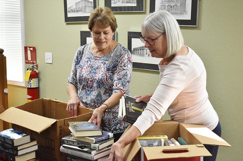 Garrett Fuller/For the News Tribune
Beth Jungmeyer, left, and Connie Walker, director of the Moniteau County Library, sort through books Wednesday at the Moniteau County Library at Wood Place in California.