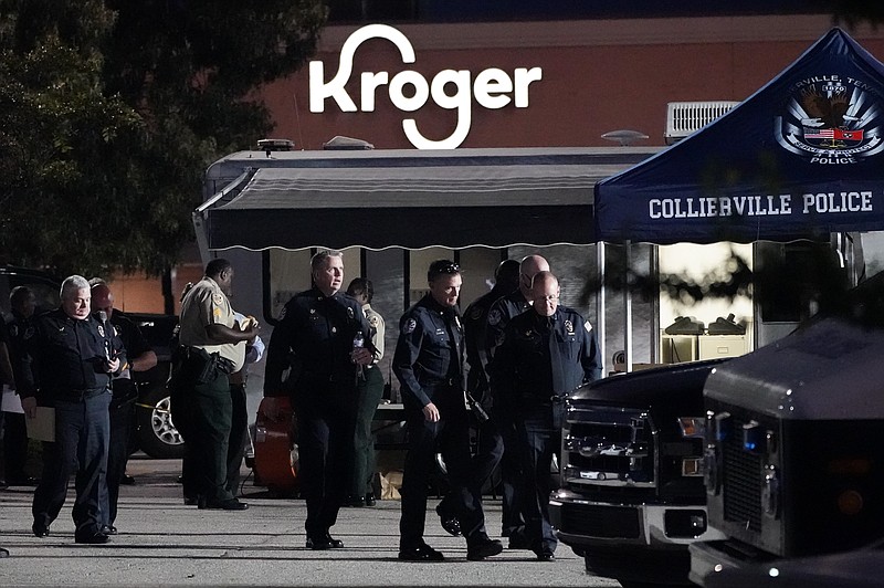 In this Thursday, Sept. 23, 2021, file photo, law enforcement personnel work in front of a Kroger grocery store as an investigation goes into the night following a shooting earlier in the day in Collierville, Tenn. An employee of the Kroger supermarket chain who was wounded in a mass shooting a year ago has sued the company, claiming it failed to protect employees from the fired contractor who killed one person and hurt.14 others. (AP Photo/Mark Humphrey, File)