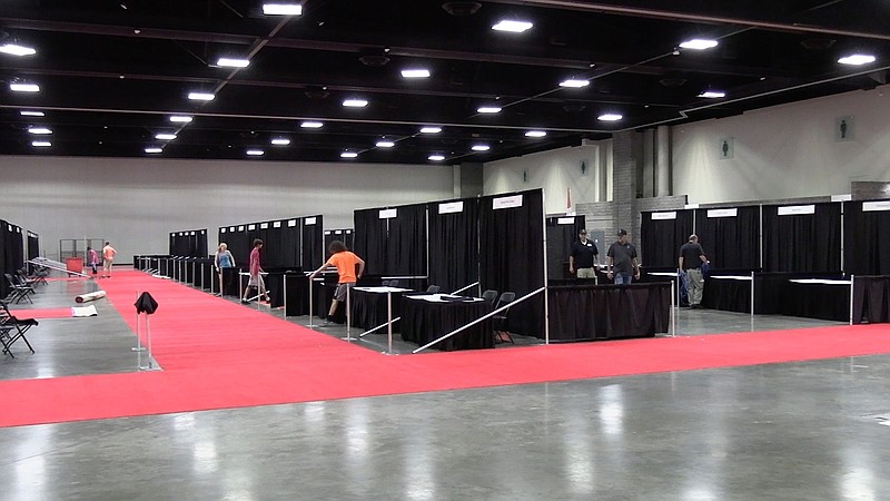 The Hot Springs Convention Center's staff works to set up booths for vendors in advance of Spa-Con 6.0 Thursday afternoon. - Photo by Lance Porter of The Sentinel-Record