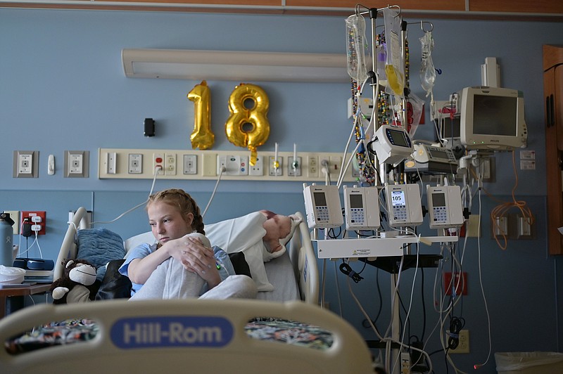 Lilly Downs, 18, sits in her bed at Denver's Rocky Mountain Hospital for Children on Aug. 30, 2022. Downs has been in and out of the hospital with long COVID. (Hyoung Chang/The Denver Post/TNS)