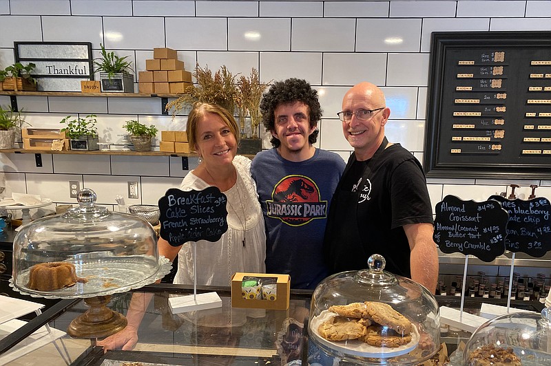 Laura, Tanner and Roger Whitmore pose behind the counter at Plate and Pour Bakery, which they run at 400 E. High St. The family plans to step away from the business at the end of the year. (News Tribune/Cameron Gerber photo)