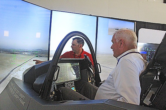 Robert Ator (right), director of military affairs for the Arkansas Economic Development Commission, flies an F-35 simulator in August 2021 as Cody Blake, cockpit demonstrator instructor pilot for Lockheed Martin, directs him at TAC Air in Fort Smith. The simulation tutorial was preceded by a talk from 3rd District Rep. Steve Womack, R-Rogers, about the Air Force’s selection for the Ebbing Air National Guard base to house up to 36 Lockheed Martin F-35 Lighting IIs and General Dynamics F-16 Fighting Falcons fighter jets for Foreign Military Sales and training.

(NWA Democrat-Gazette/Max Bryan)