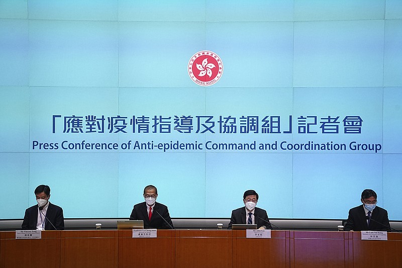 Hong Kong Chief Executive John Lee, second from right, speaks during a news conference in Hong Kong, Friday, Sep. 23, 2022. Hong Kong's leader announced the city would no longer require incoming travelers to quarantine in designated hotels as the city seeks to open up globally after nearly two years. (AP Photo/Lam Yik)