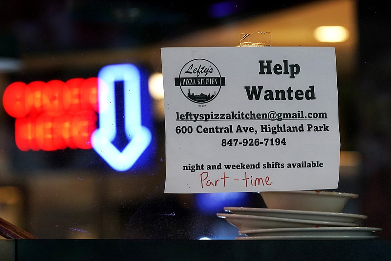 FILE - Hiring sign is displayed at a restaurant in Highland Park, Ill., Thursday, July 14, 2022. Fewer Americans filed for unemployment benefits last week as the labor market continues to shine despite weakening elements of the U.S. economy. Applications for jobless aid for the week ending Aug. 27, fell by 5,000 to 232,000, the Labor Department reported Thursday, Sept. 1.  (AP Photo/Nam Y. Huh)