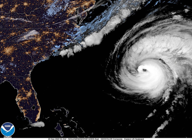 This image provided by the National Hurricane Center National Oceanic and Atmospheric Administration shows a satellite view as Hurricane Fiona moves up the United States Atlantic coast, Thursday night, Sept. 22, 2022. Hurricane Fiona pounded Bermuda with heavy rains and winds as it swept by the island on a route that has it reaching northeastern Canada as a still-powerful storm late Friday. (NOAA via AP)