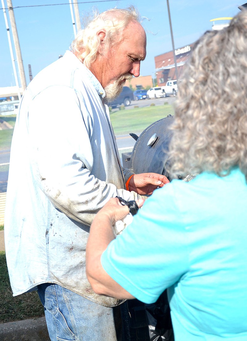 TIMES photograph by Annette Beard
Members of Beta Alpha and the Veterans of Foreign Wars Post 8109, Pea Ridge, joined forces cooking and selling chicken Saturday, Sept. 24, 2022, as a fundraiser. Norm Keene with the VFW checks on the chicken in the grill to give some to a Beta Alpha member for a customer.