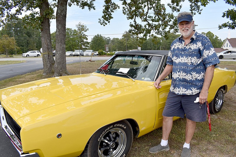 Rachel Dickerson/The Weekly Vista Craig Marten of Bella Vista is pictured with his 1968 Dodge Charger at the Highlands Church car show on Saturday.